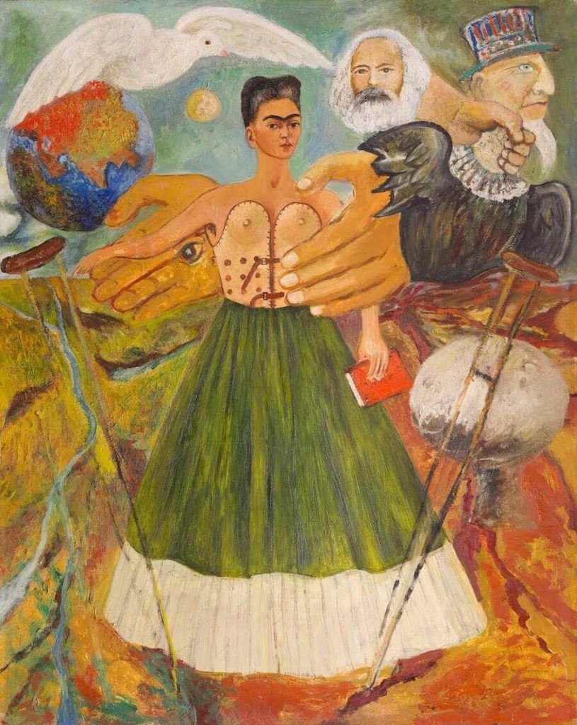 Frida Kahlo's painting "Marxism Will Give Health to the Sick." The painting depicts the artist in a long, wide-flaring green and white dress, crutches cast off to either side of her, Karl Marx's head above hers, the Marx figure throttling a capitalist-faced eagle. A white bird that might be a dove glides above the earth and the moon in the background.